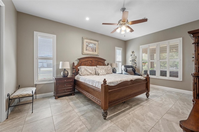 tiled bedroom featuring multiple windows and ceiling fan