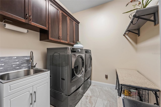 laundry area with sink, cabinets, and washer and dryer