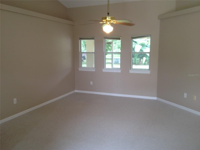 carpeted empty room with baseboards and a ceiling fan