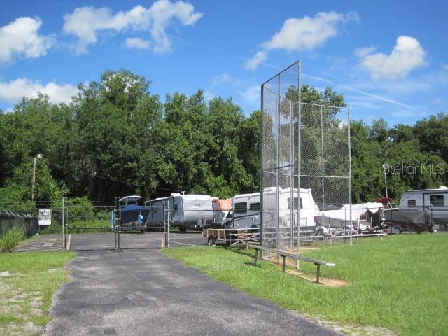 view of property's community with a gate and fence