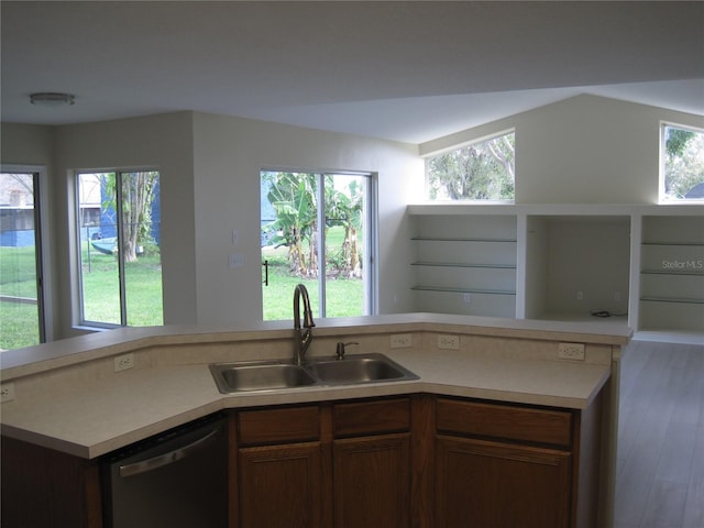 kitchen with a healthy amount of sunlight, light countertops, dishwasher, and a sink