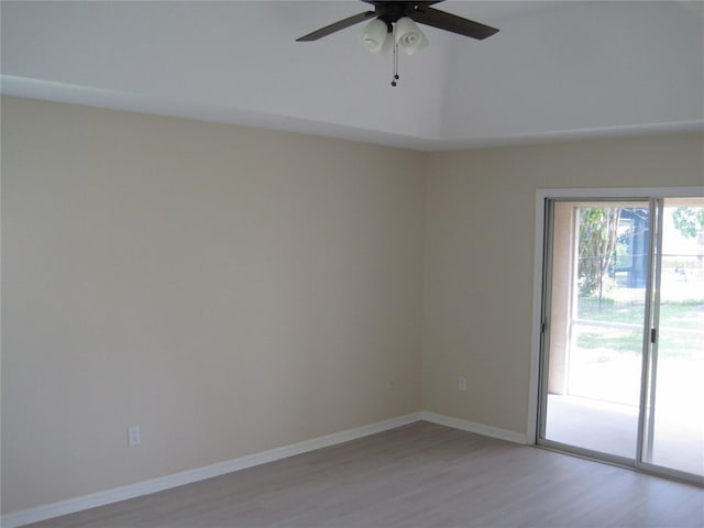 spare room featuring light wood-style floors, ceiling fan, and baseboards