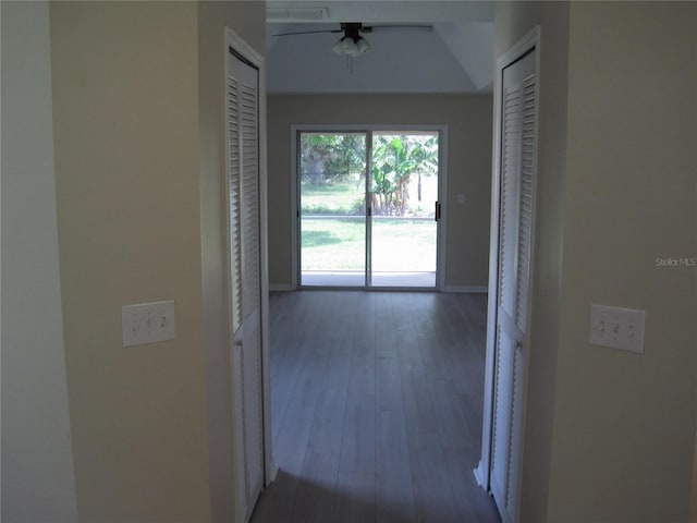 hallway featuring wood finished floors and baseboards