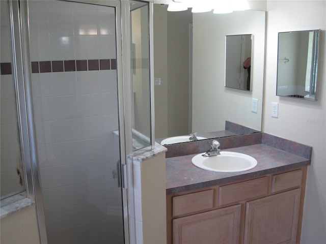 full bath featuring a stall shower and vanity