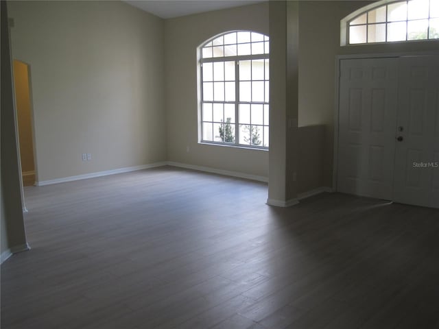 entryway with baseboards and wood finished floors