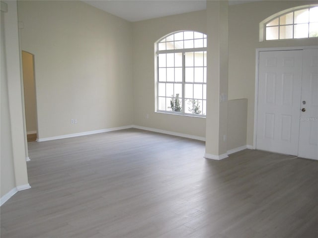 entryway with baseboards and wood finished floors