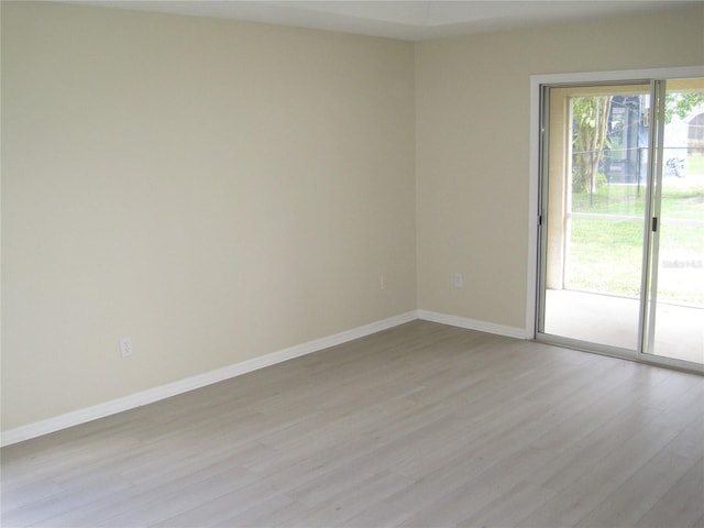 empty room featuring light wood-style floors and baseboards