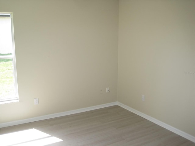 unfurnished room featuring light wood-style floors and baseboards