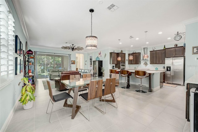 dining room with crown molding and light tile patterned floors