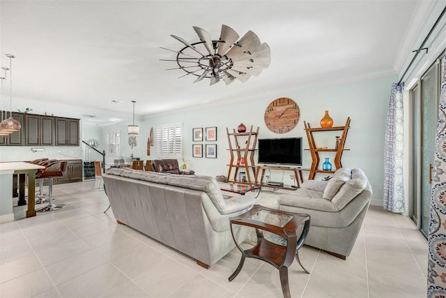 tiled living room with crown molding and ceiling fan