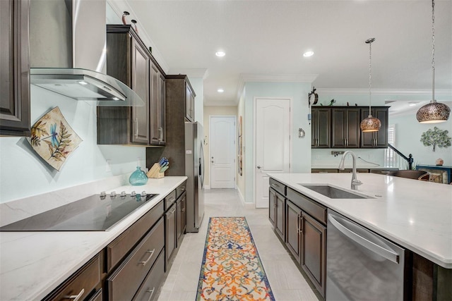 kitchen featuring wall chimney exhaust hood, dark brown cabinetry, sink, appliances with stainless steel finishes, and pendant lighting