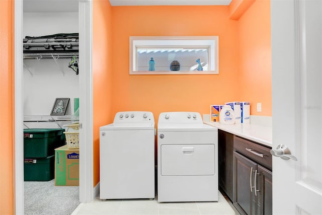 laundry area featuring cabinets and washing machine and dryer