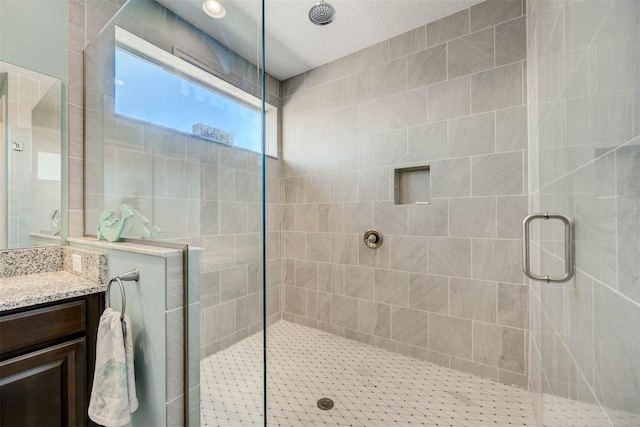 bathroom with vanity and a shower with shower door