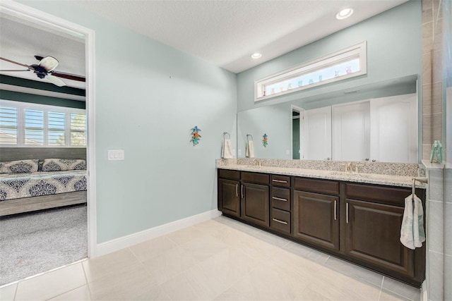 bathroom featuring vanity, ceiling fan, tile patterned floors, and a textured ceiling