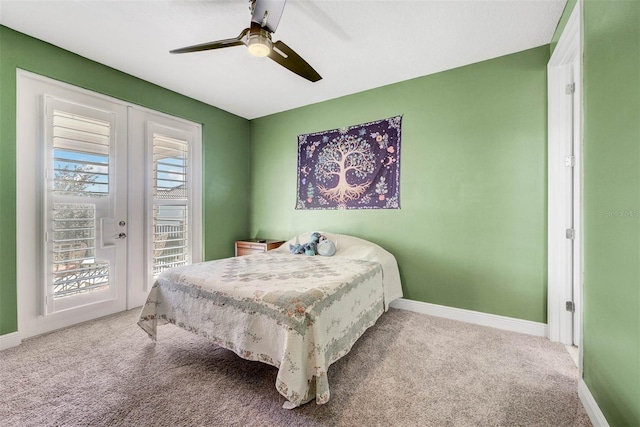 bedroom with carpet flooring, access to outside, ceiling fan, and french doors