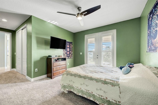 carpeted bedroom featuring french doors and ceiling fan