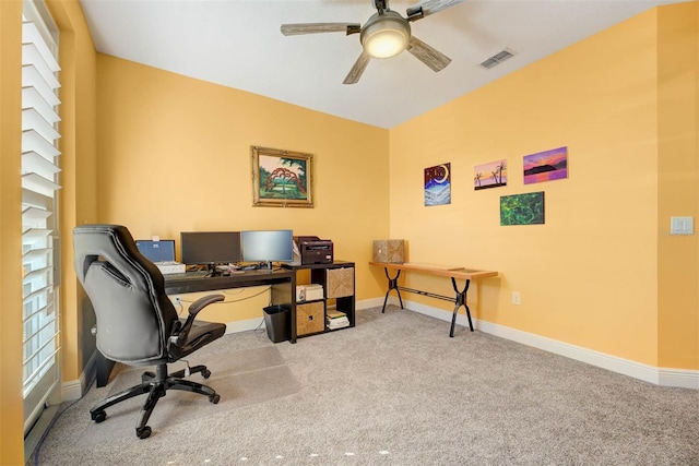 carpeted home office featuring ceiling fan