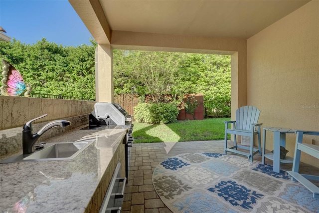 view of patio / terrace with area for grilling and sink