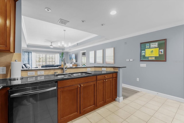 kitchen featuring a tray ceiling, black dishwasher, sink, and dark stone countertops