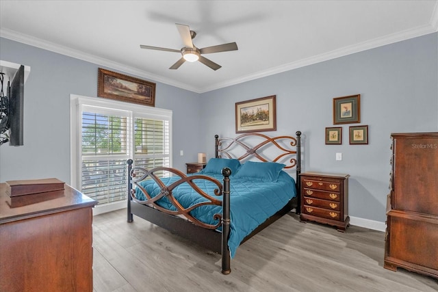 bedroom with ornamental molding, ceiling fan, and light wood-type flooring