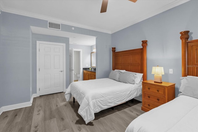 bedroom featuring crown molding, ceiling fan, ensuite bath, and light hardwood / wood-style flooring