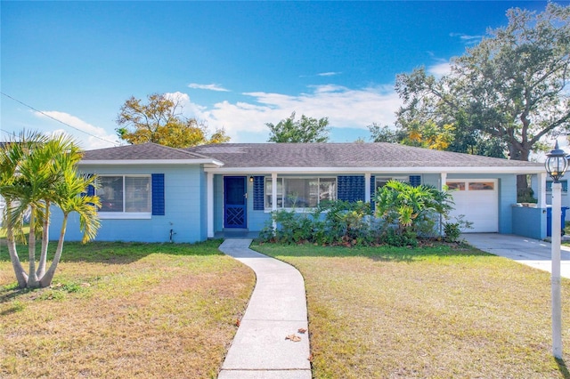 ranch-style house with a garage and a front lawn