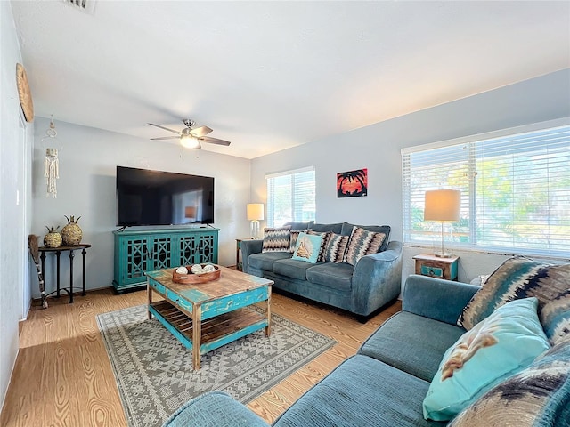 living room with ceiling fan and light wood-type flooring