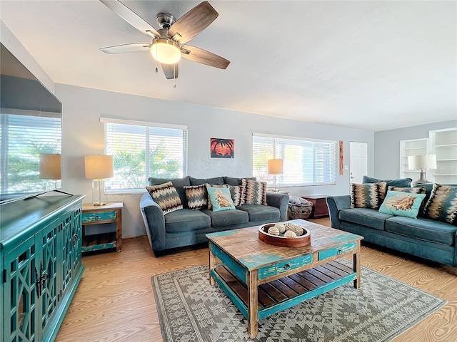 living room with ceiling fan and light wood-type flooring