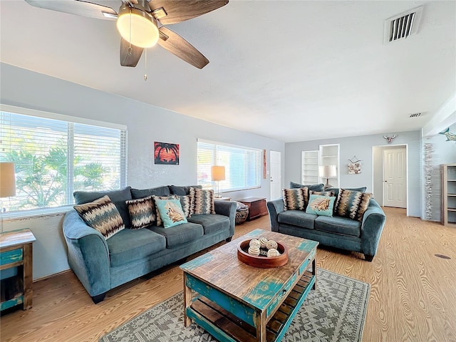 living room featuring ceiling fan, a healthy amount of sunlight, and light hardwood / wood-style flooring