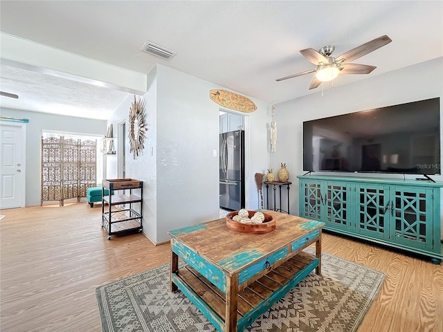 living room with ceiling fan and light wood-type flooring