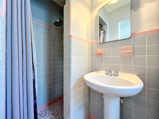 bathroom featuring tile walls and walk in shower