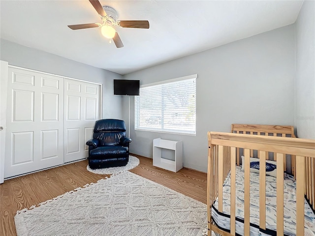 bedroom featuring hardwood / wood-style flooring, a closet, and ceiling fan