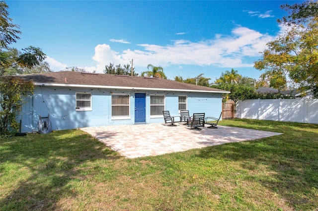 rear view of house featuring a yard and a patio