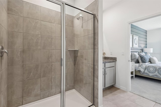 bathroom with tile patterned flooring, vanity, and a shower with door