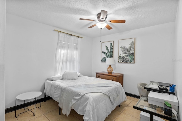 tiled bedroom with ceiling fan and a textured ceiling