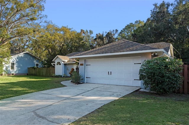 ranch-style home featuring a garage and a front lawn