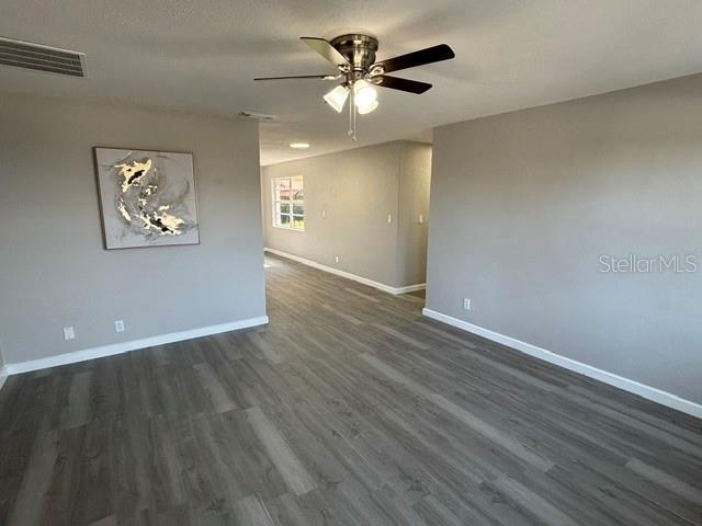 empty room featuring dark hardwood / wood-style floors and ceiling fan