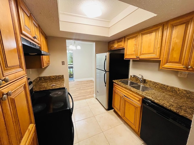 kitchen with sink, a textured ceiling, light tile patterned floors, a raised ceiling, and black appliances