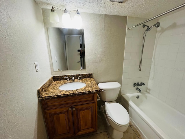 full bathroom featuring vanity, a textured ceiling, tile patterned floors, toilet, and tiled shower / bath