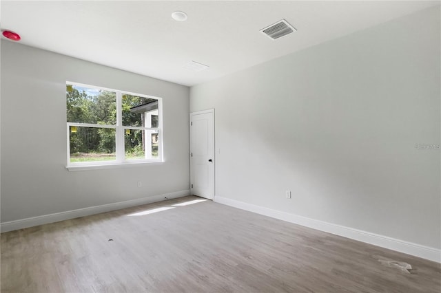 spare room featuring hardwood / wood-style floors