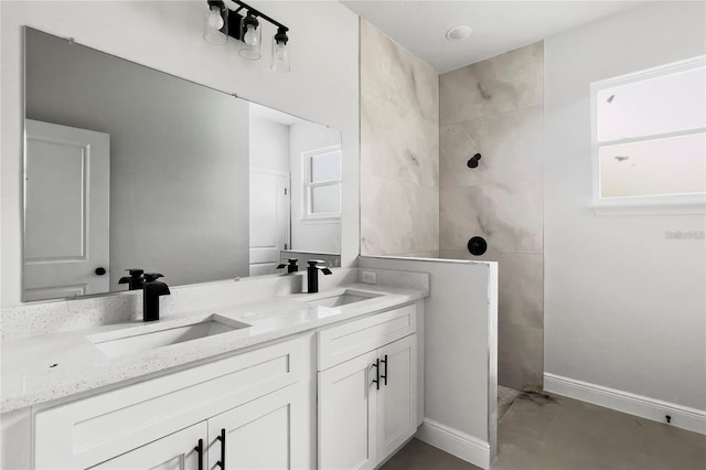 bathroom with vanity and tiled shower