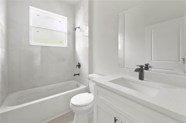 full bathroom featuring tiled shower / bath, vanity, and toilet