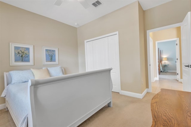 carpeted bedroom featuring a closet and ceiling fan