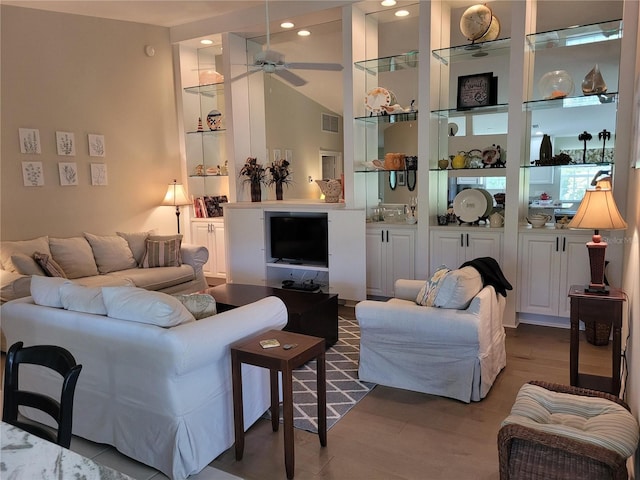 living room with ceiling fan, hardwood / wood-style floors, and built in features