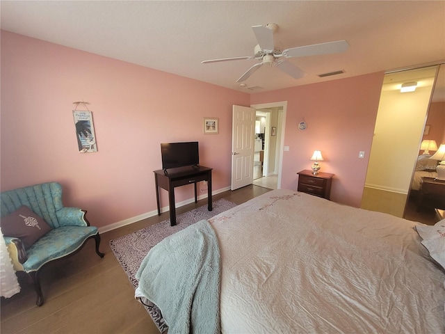 bedroom with hardwood / wood-style floors and ceiling fan