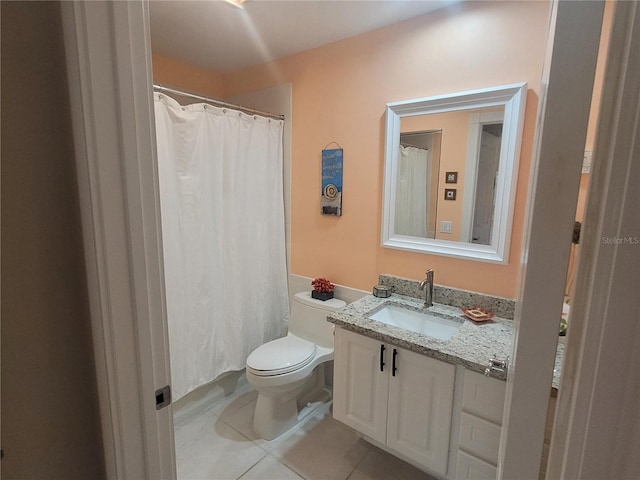 bathroom featuring vanity, tile patterned flooring, and toilet