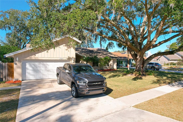 ranch-style house featuring a garage and a front lawn