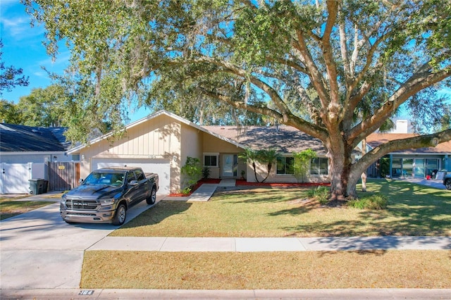 single story home featuring a garage and a front lawn