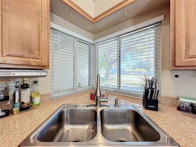 kitchen with light brown cabinetry and sink