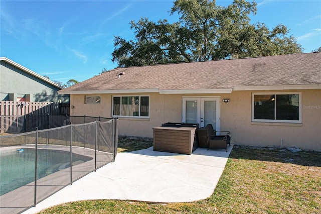 back of house with french doors, a yard, a fenced in pool, and a patio